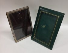 A plain silver picture frame together with a leath