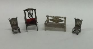 A group of four novelty miniature silver chairs of