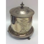 A silver plated biscuit barrel decorated with leav