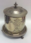 A silver plated biscuit barrel decorated with leav