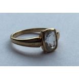 A 9 carat single stone ring in rubover mount. Appr