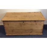A large pine hinged top trunk. Est. £20 - £30.