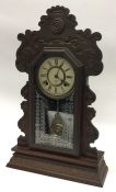 An American carved mantle clock with white enamell