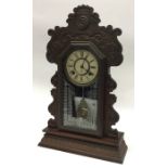 An American carved mantle clock with white enamell