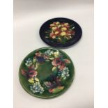 MOORCROFT: Two decorative wall plates of typical d