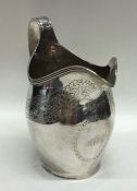 A massive Georgian helmet shaped silver cream jug.