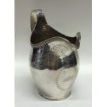 A massive Georgian helmet shaped silver cream jug.