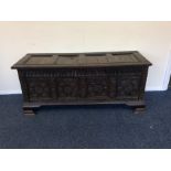 A large hinged top four panel coffer on shaped fee