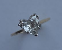 A heart shaped diamond mounted as a ring in 18 car