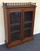 An Edwardian mahogany glazed cabinet with gallery