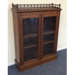 An Edwardian mahogany glazed cabinet with gallery