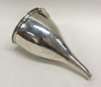 A Georgian silver wine funnel and strainer with re