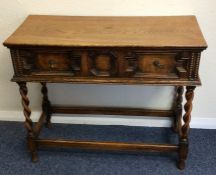 An oak single drawer hall table with barley twist