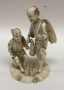 An Antique carved ivory figure of fishermen on car