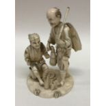 An Antique carved ivory figure of fishermen on car