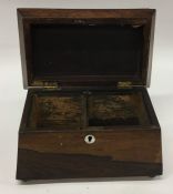 A rosewood sarcophagus shaped tea caddy on ball fe