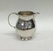 A George I silver sparrow beak cream jug on pedest