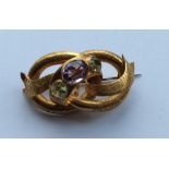 A large Antique amethyst and peridot brooch of twi
