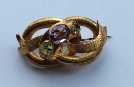 A large Antique amethyst and peridot brooch of twi