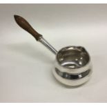 An attractive silver brandy pan with turned handle