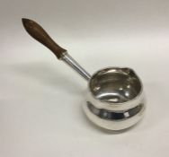 An attractive silver brandy pan with turned handle