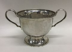 A stylish silver sugar bowl of beaten texture. Lon