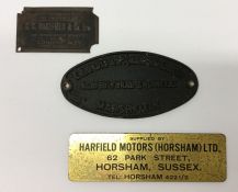 Three varying sized metal name plates comprising a