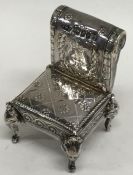 A novelty silver model of a Sudan chair with scrol