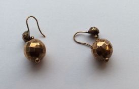 A pair of gold drop earrings in the form of balls