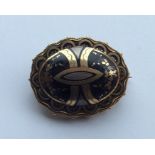 A piqué oval Victorian target brooch with rope twi