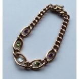 SUFFRAGETTE: An unusual 15 carat gold bracelet wit