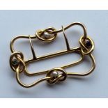 SUFFRAGETTE: A rare gold buckle of knot decoration