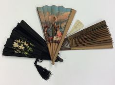 A group of four painted fans mounted with tassels.