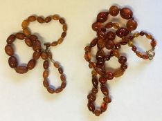 Two graduated strings of amber beads. Approx. 55 g