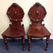 A pair of oak hall chairs on turned supports. Est.