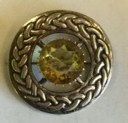 A circular Scottish silver brooch of typical desig