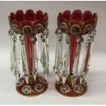 A pair of large tall decorative cranberry lustres