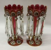 A pair of large tall decorative cranberry lustres