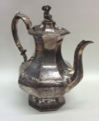 A heavy Victorian silver coffee pot decorated with