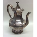 A heavy Victorian silver coffee pot decorated with