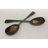 A pair of silver aesthetic salad servers with flut