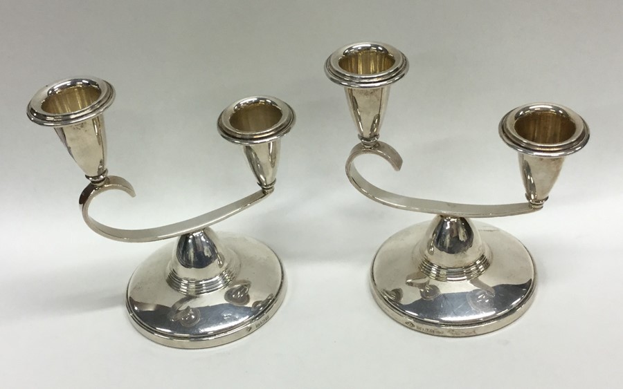A pair of stylish silver candlesticks on circular