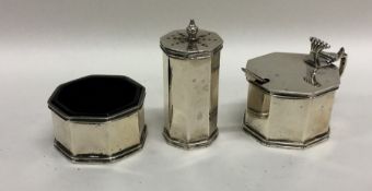 An Edwardian silver hinged top three piece cruet.