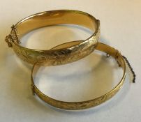 Two gilt and engraved bangles. Est. £10 - £15.