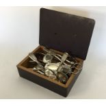 A box containing silver plated sugar tongs, grape