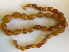 A graduated string of amber beads. Approx. 55 gram