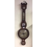 A mahogany banjo barometer with inlaid decoration.