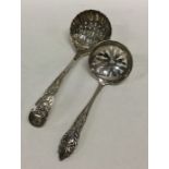 A silver sifter spoon with fluted bowl together wi