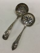 A silver sifter spoon with fluted bowl together wi