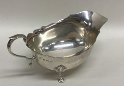 An Edwardian silver sauce boat with card cut rim.